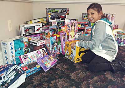 youngest SAM helper, Ariana, to display the over 70 toys donated