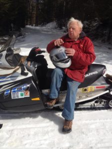 Stan Kopala rides a snowmobile